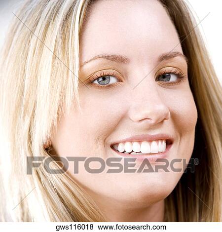 Stock Photo - Portrait of a young woman smiling. Fotosearch