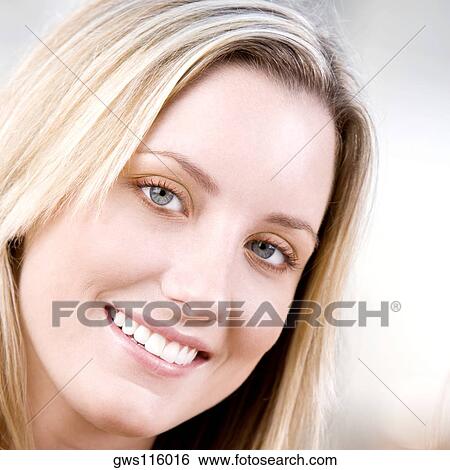 Portrait of a young woman smiling View Large Photo Image Stock Photograph - Portrait of a young woman smiling. Fotosearch