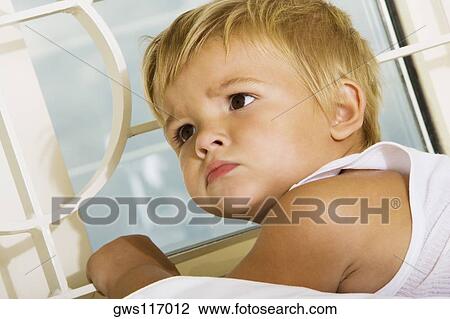 Stock Image - Close-up of a boy lying on the bed. Fotosearch