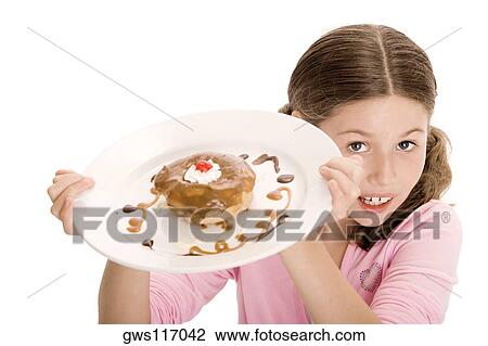 High angle view of a girl holding a donut in a plate View Large Photo Image Stock Image - High angle view of a girl holding a donut in a plate. Fotosearch