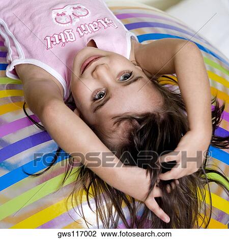 High angle view of a girl lying on an inflatable ball View Large Photo Image Stock Image - High angle view of a girl lying on an inflatable ball. Fotosearch
