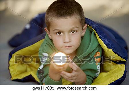 Portrait of a boy holding a flashlight View Large Photo Image Stock Photography - Portrait of a boy holding a flashlight. Fotosearch