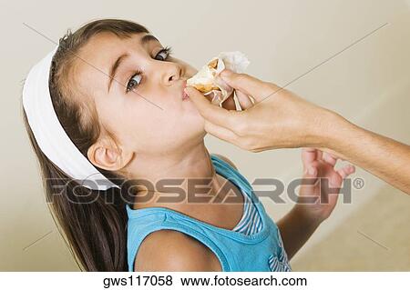 Portrait of a girl eating View Large Photo Image Stock Photo - Portrait of a girl eating. Fotosearch