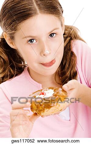 Portrait of a girl holding a donut licking her lips View Large Photo Image Stock Image - Portrait of a girl holding a donut licking her lips. Fotosearch