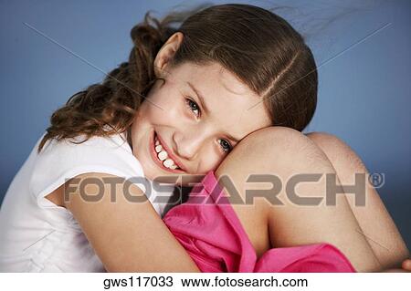 Portrait of a girl hugging her knees View Large Photo Image Stock Image - Portrait of a girl hugging her knees. Fotosearch