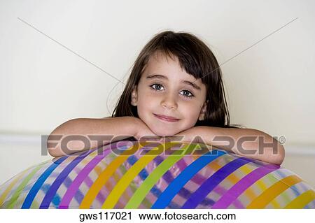 Portrait of a girl leaning on an inflatable ball View Large Photo Image Stock Image - Portrait of a girl leaning on an inflatable ball. Fotosearch