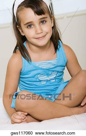 Portrait of a girl sitting with her legs crossed View Large Photo Image Stock Image - Portrait of a girl sitting with her legs crossed. Fotosearch