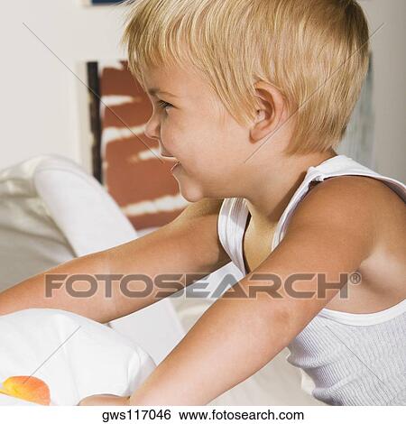 Side profile of a boy smiling View Large Photo Image Stock Photograph - Side profile of a boy smiling. Fotosearch