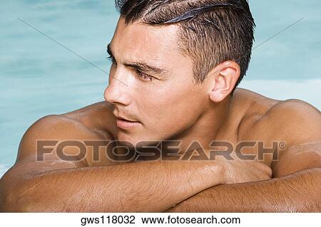 Close-up of a young man looking sideways View Large Photo Image Stock Image - Close-up of a young man looking sideways. Fotosearch