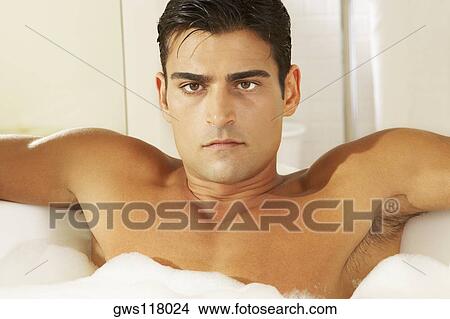 Portrait of a bare chested young man in a bubble bath View Large Photo Image Picture - Portrait of a bare chested young man in a bubble bath. Fotosearch