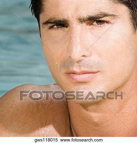 Stock Photography - Portrait of a mid adult man in a swimming pool. Fotosearch