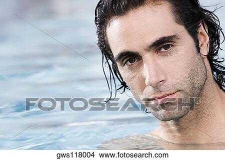 Portrait of a mid adult man swimming in a swimming pool View Large Photo Image Picture - Portrait of a mid adult man swimming in a swimming pool. Fotosearch