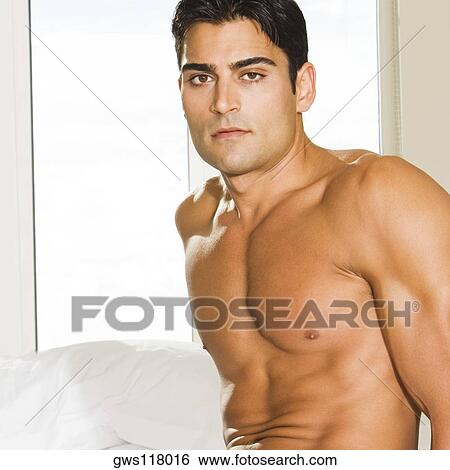 Portrait of a young man looking serious View Large Photo Image Stock Photograph - Portrait of a young man looking serious. Fotosearch
