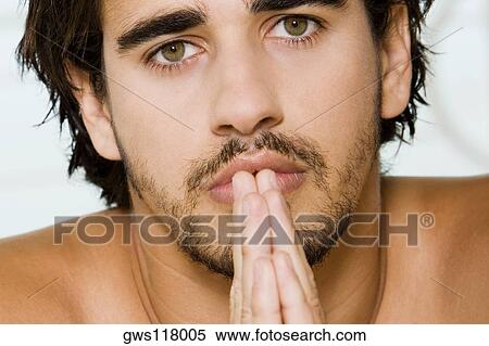 Portrait of a young man praying View Large Photo Image Stock Photography - Portrait of a young man praying. Fotosearch