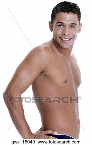 Portrait of a young man standing with his hand on his waist View Large Photo Image Stock Image - Portrait of a young man standing with his hand on his waist. Fotosearch