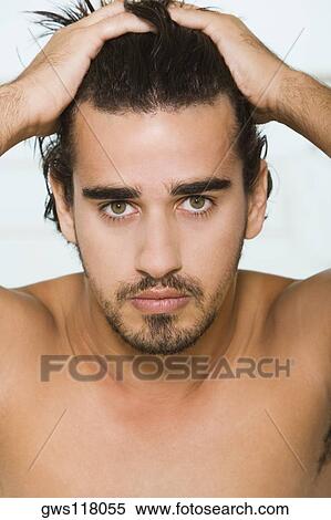 Portrait of a young man with his hands on his head View Large Photo Image Stock Photography - Portrait of a young man with his hands on his head. Fotosearch