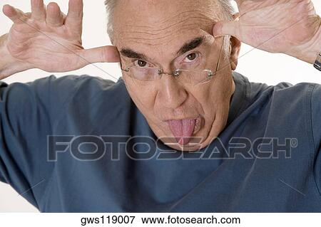 Close-up of a senior man making a face View Large Photo Image Stock Photo - Close-up of a senior man making a face. Fotosearch