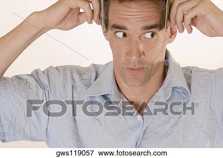 Close-up of a young man looking sideways View Large Photo Image Stock Photo - Close-up of a young man looking sideways. Fotosearch