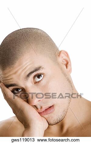 Close-up of a young man thinking View Large Photo Image Stock Image - Close-up of a young man thinking. Fotosearch