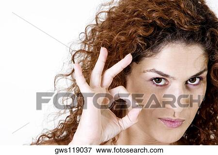 Close-up of a young woman making an ok sign View Large Photo Image Stock Photo - Close-up of a young woman making an ok sign. Fotosearch