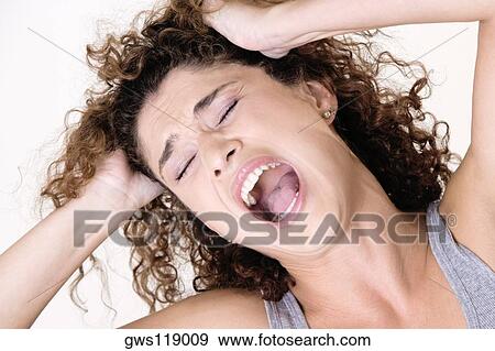Close-up of a young woman shouting View Large Photo Image Stock Photo - Close-up of a young woman shouting. Fotosearch