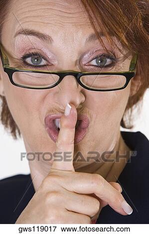 Portrait of a businesswoman with her finger on her lips View Large Photo Image Stock Photo - Portrait of a businesswoman with her finger on her lips. Fotosearch