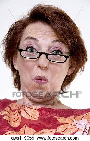 Portrait of a senior woman puckering her lips View Large Photo Image Stock Photography - Portrait of a senior woman puckering her lips. Fotosearch