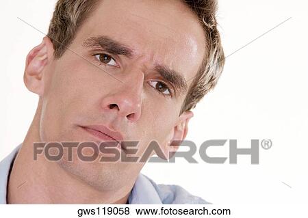 Portrait of a young man looking serious View Large Photo Image Stock Photo - Portrait of a young man looking serious. Fotosearch