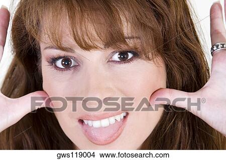 Portrait of a young woman making a face View Large Photo Image Picture - Portrait of a young woman making a face. Fotosearch