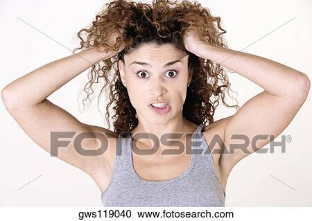 Portrait of a young woman making a face View Large Photo Image Stock Image - Portrait of a young woman making a face. Fotosearch