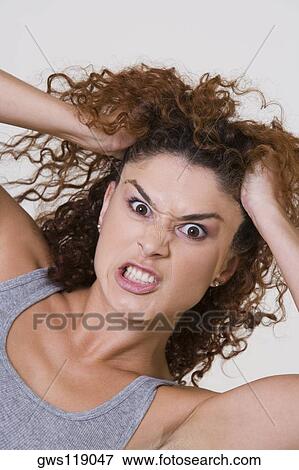 Portrait of a young woman making a face View Large Photo Image Stock Photo - Portrait of a young woman making a face. Fotosearch