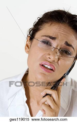 Portrait of a young woman using a mobile phone View Large Photo Image Stock Photography - Portrait of a young woman using a mobile phone. Fotosearch