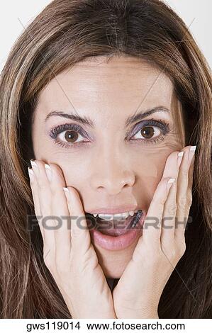 Picture - Portrait of a young woman with her hands on her face. Fotosearch