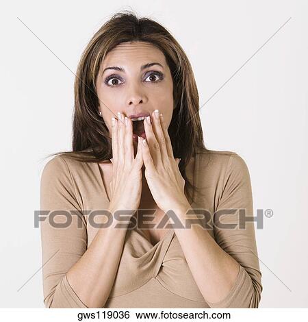 Portrait of a young woman with her hands on her mouth View Large Photo Image Stock Photograph - Portrait of a young woman with her hands on her mouth. Fotosearch