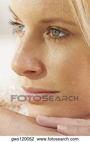 Stock Image - Close-up of a young woman thinking. Fotosearch