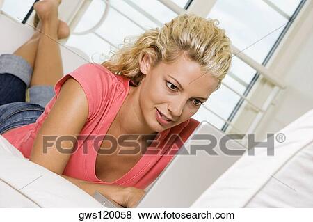 Stock Photo - Close-up of a young woman working on a laptop. Fotosearch