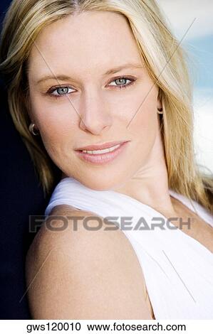 Stock Image - Portrait of a young woman smiling. Fotosearch