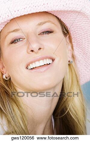 Stock Photograph - Portrait of a young woman wearing a hat. Fotosearch
