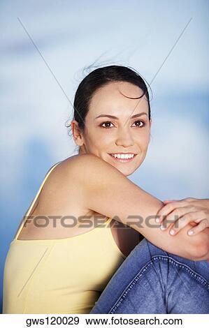 Side profile of a young woman smiling View Large Photo Image Stock Photo - Side profile of a young woman smiling. Fotosearch
