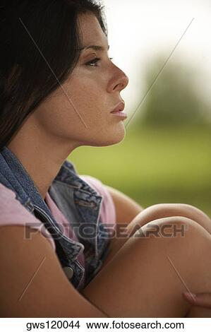 Picture - Side profile of a young woman thinking. Fotosearch