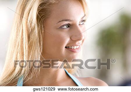 Close-up of a young woman smiling View Large Photo Image Stock Photo - Close-up of a young woman smiling. Fotosearch