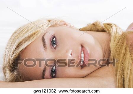 Portrait of a young woman lying down View Large Photo Image Stock Image - Portrait of a young woman lying down. Fotosearch
