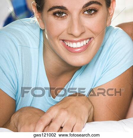 Stock Image - Portrait of a young woman smiling. Fotosearch