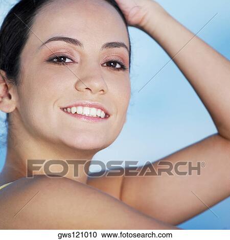 Stock Image - Portrait of a young woman smiling. Fotosearch