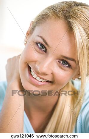Portrait of a young woman smiling View Large Photo Image Stock Photograph - Portrait of a young woman smiling. Fotosearch