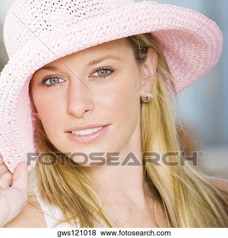 Portrait of a young woman wearing a hat View Large Photo Image Stock Photo - Portrait of a young woman wearing a hat. Fotosearch