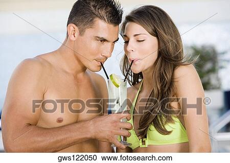 Close-up of a young couple drinking lemonade View Large Photo Image Stock Image - Close-up of a young couple drinking lemonade. Fotosearch