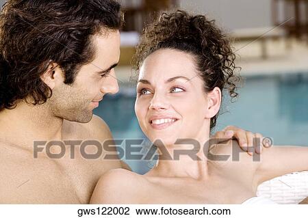 Close-up of a young woman and a mid adult man looking at each other View Large Photo Image Stock Image - Close-up of a young woman and a mid adult man looking at each other. Fotosearch