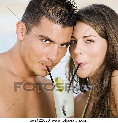 Stock Image - Portrait of a young couple drinking lemonade. Fotosearch