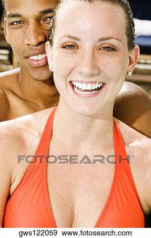 Portrait of a young couple smiling View Large Photo Image Stock Photo - Portrait of a young couple smiling. Fotosearch